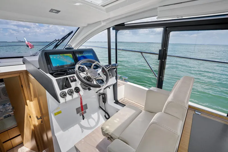 Slide: The Image of 2023 Sealine C335V yacht cockpit with modern navigation system and ocean view. - 16