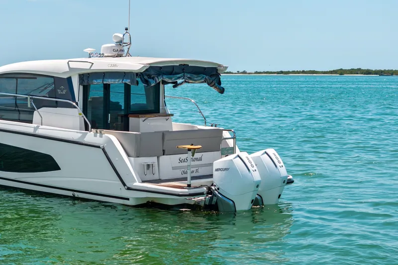 Slide: The Image of 2023 Sealine C335V boat with twin Mercury engines on clear blue water. - 4