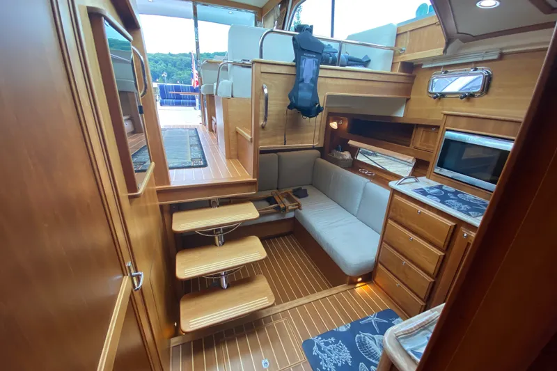 Slide: The Image of Interior of 2014 Sabre 38 Salon Express yacht with wooden finish and cozy seating area. - 21