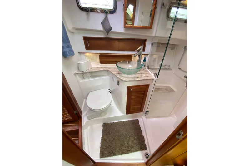 Slide: The Image of Luxurious bathroom in 2014 Sabre 38 Salon Express yacht with glass sink and shower. - 25