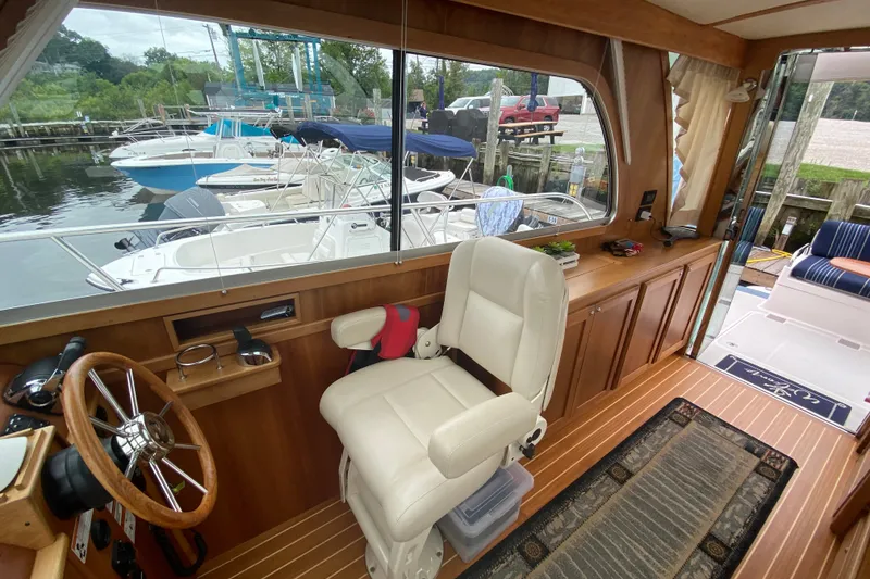 Slide: The Image of Interior of 2014 Sabre 38 Salon Express yacht with helm and seating area. - 13