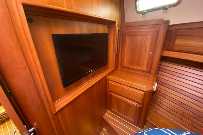 Slide: The Image of Interior of 2014 Sabre 38 Salon Express with wooden cabinetry and mounted TV. - 19