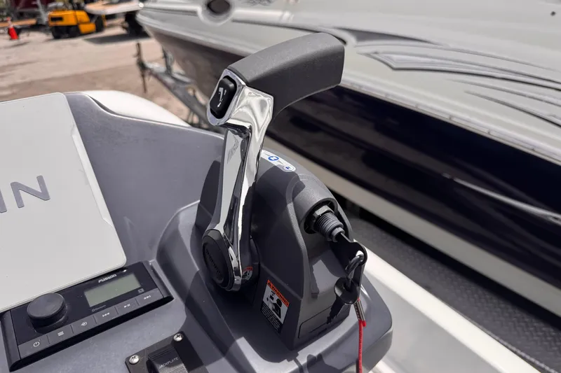 Slide: The Image of Throttle control on a 1980 Boston Whaler 17 Montauk boat, featuring modern navigation equipment. - 12