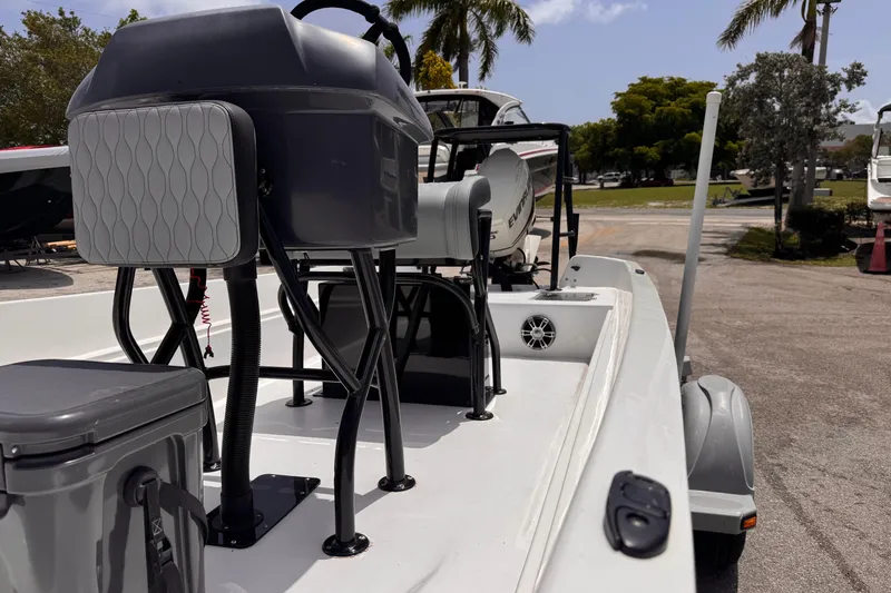 Slide: The Image of 1980 Boston Whaler 17 Montauk boat interior with modern seating and equipment, parked outdoors. - 9
