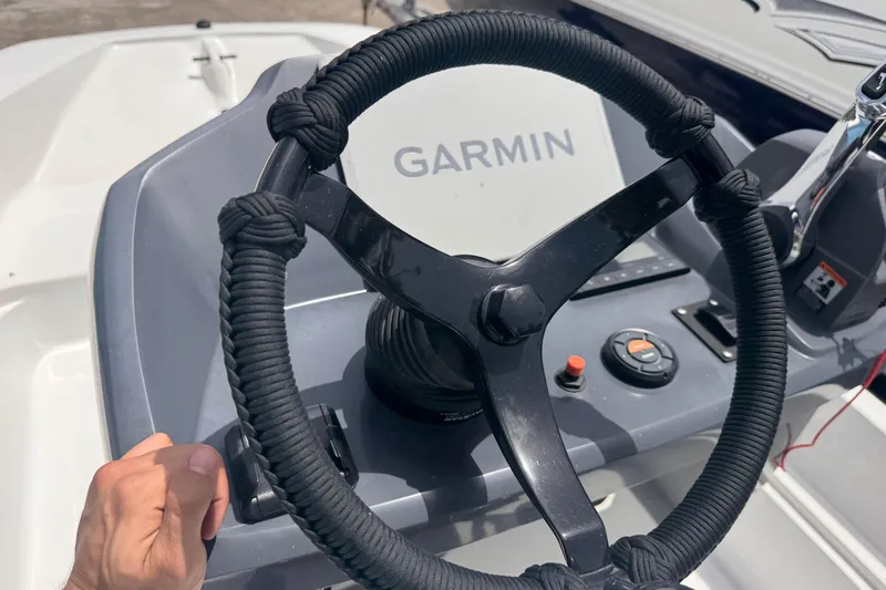 Slide: The Image of Steering wheel of a 1980 Boston Whaler 17 Montauk boat with Garmin navigation. - 11