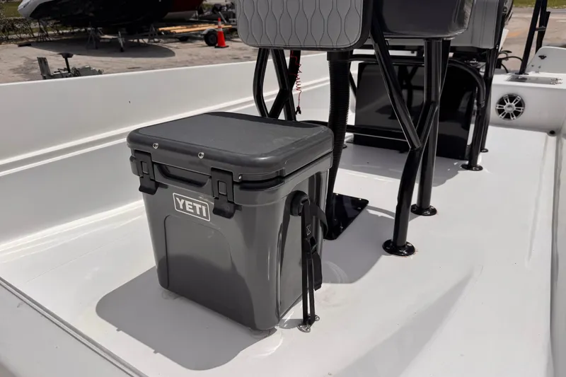 Slide: The Image of YETI cooler on 1980 Boston Whaler 17 Montauk boat deck, featuring black seating. - 8
