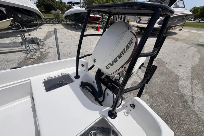 Slide: The Image of 1980 Boston Whaler 17 Montauk with Evinrude outboard motor in a boatyard setting. - 7