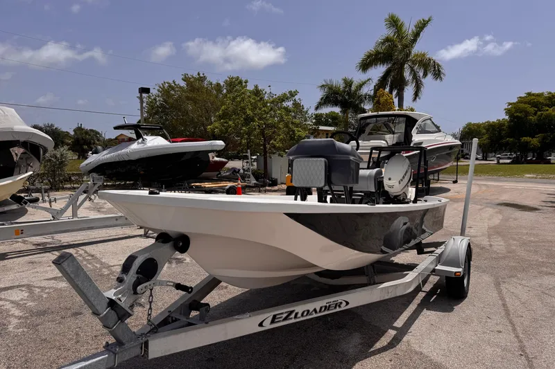 Slide: The Image of 1980 Boston Whaler 17 Montauk boat on trailer, parked outdoors under clear sky. - 10