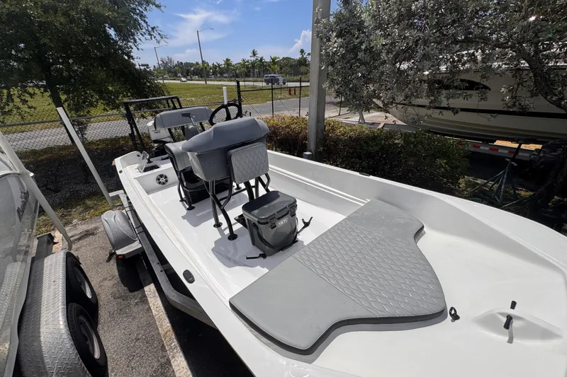 Slide: The Image of 1980 Boston Whaler 17 Montauk boat on trailer, parked outdoors under sunny skies. - 6