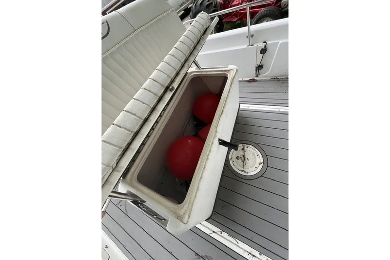 Slide: The Image of Open storage compartment on 2004 Boston Whaler 220 Dauntless boat with red buoys inside. - 17