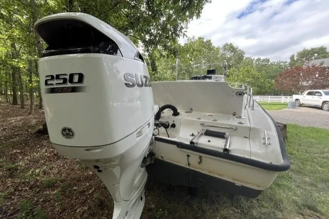 Slide: The Image of 2004 Boston Whaler 220 Dauntless boat with Suzuki 250 SS outboard motor in a wooded area. - 7