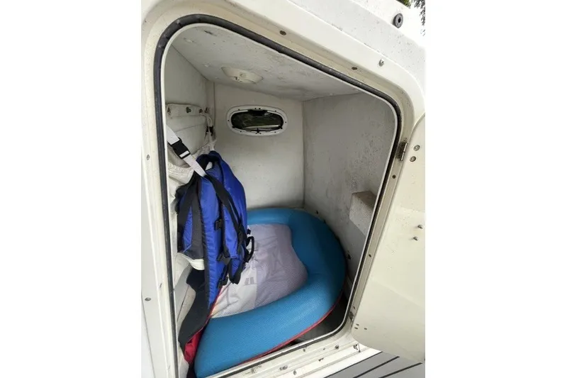 Slide: The Image of Interior cabin of a 2004 Boston Whaler 220 Dauntless with life jacket and cushion. - 12
