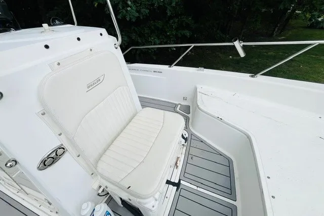 Slide: The Image of 2004 Boston Whaler 220 Dauntless boat interior with white seating and sleek design. - 18