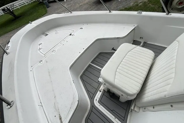 Slide: The Image of 2004 Boston Whaler 220 Dauntless boat interior with white seating and gray flooring. - 3