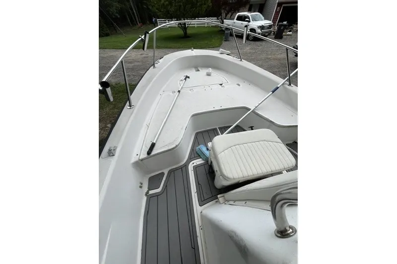 Slide: The Image of 2004 Boston Whaler 220 Dauntless boat interior with seating and deck view. - 16