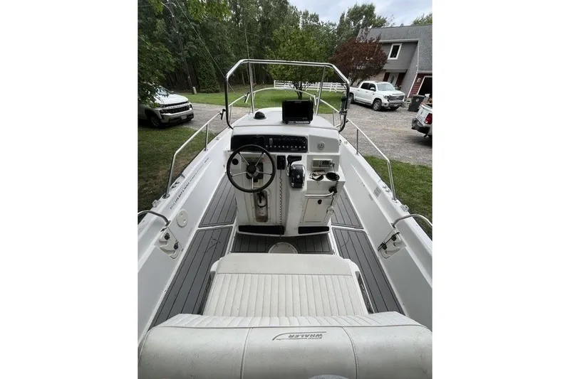 Slide: The Image of 2004 Boston Whaler 220 Dauntless boat interior with steering console and seating. - 1