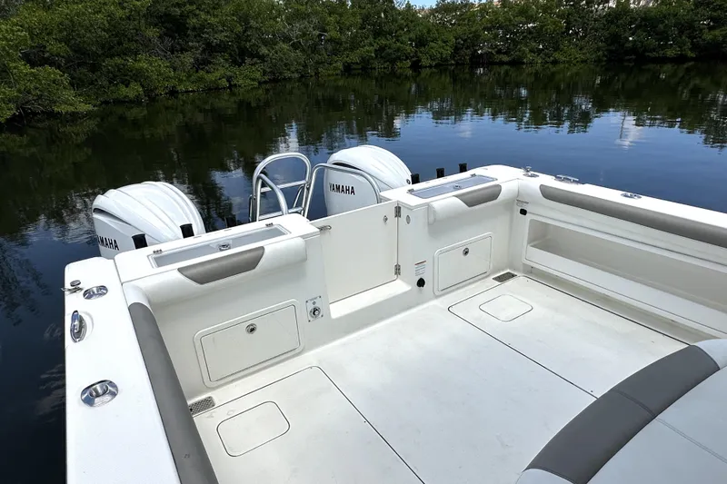 Slide: The Image of 2022 World Cat 325 CC boat with Yamaha engines, docked on a calm river. - 15