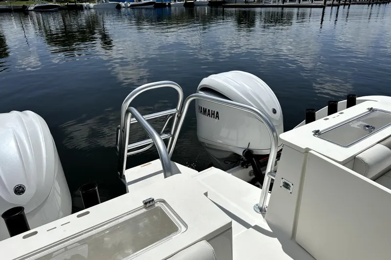 Slide: The Image of 2022 World Cat 325 CC boat with Yamaha outboard engines docked by the water. - 7