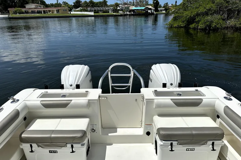 Slide: The Image of 2022 World Cat 325 CC boat with twin engines on a calm waterway. - 5