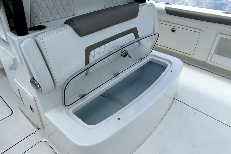Slide: The Image of 2022 World Cat 325 CC boat seat with open storage compartment. - 13