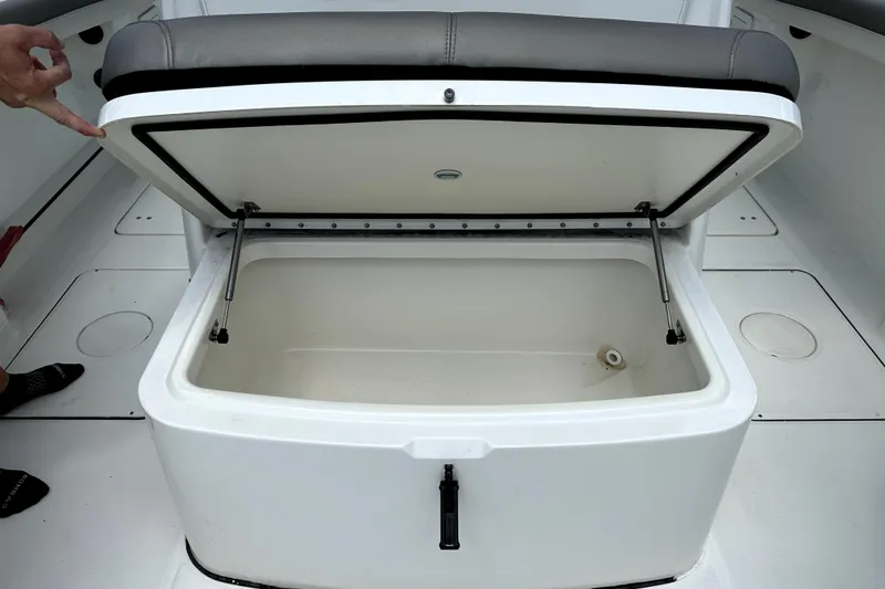 Slide: The Image of Open storage compartment on a 2022 World Cat 325 CC boat, showcasing interior space. - 12