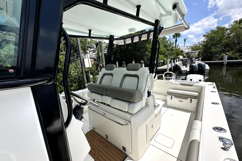 Slide: The Image of 2022 World Cat 325 CC boat interior with luxurious seating and sleek design. - 8