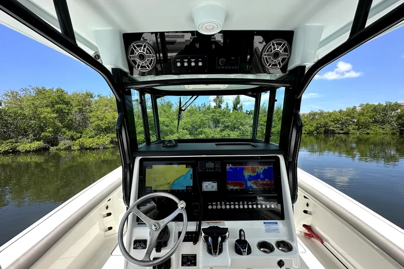 Slide: The Image of Cockpit view of 2022 World Cat 325 CC boat with navigation screens and steering wheel. - 4