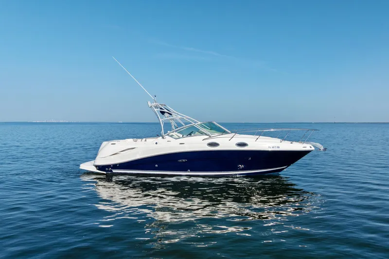Slide: The Image of 2005 Sea Ray 270 Amberjack boat on calm blue water under clear sky. - 2