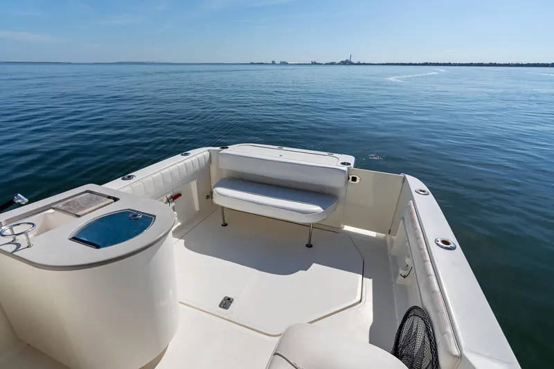 Slide: The Image of 2005 Sea Ray 270 Amberjack boat deck with seating, overlooking calm blue waters. - 14