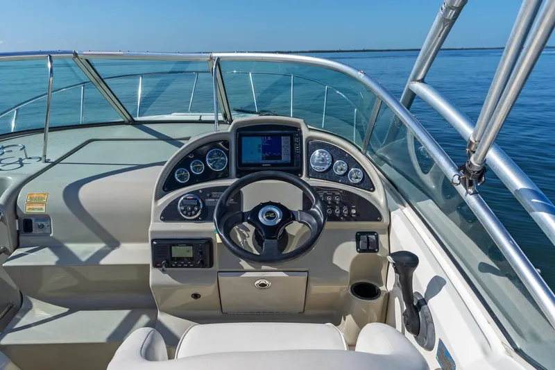 Slide: The Image of Cockpit view of 2005 Sea Ray 270 Amberjack boat with steering wheel and navigation instruments. - 16