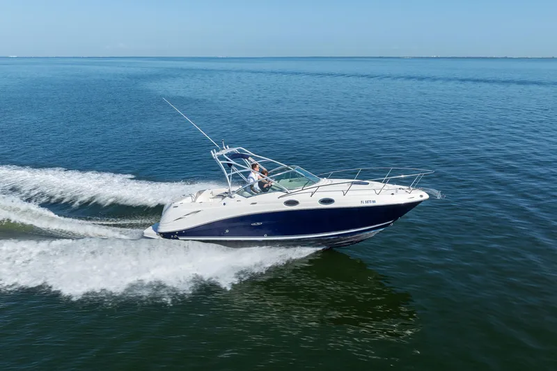Slide: The Image of 2005 Sea Ray 270 Amberjack cruising on open water under clear blue skies. - 6