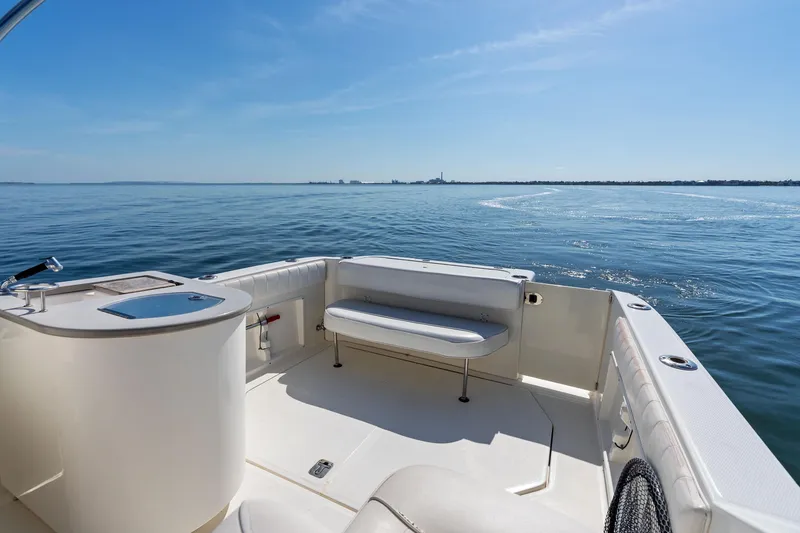 Slide: The Image of 2005 Sea Ray 270 Amberjack boat interior with seating, overlooking calm blue waters. - 13