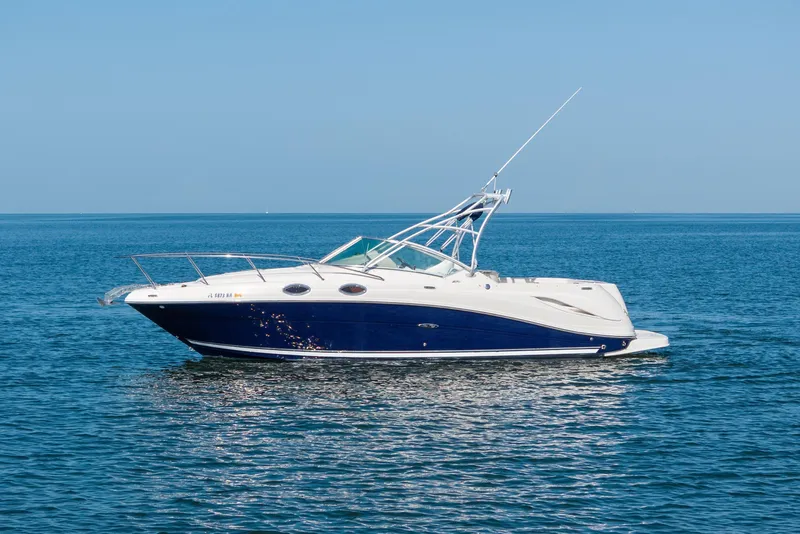 Slide: The Image of 2005 Sea Ray 270 Amberjack boat on calm blue water under clear sky. - 3