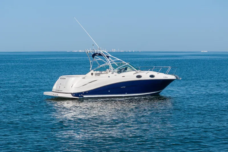 Slide: The Image of 2005 Sea Ray 270 Amberjack boat cruising on calm blue waters. - 1