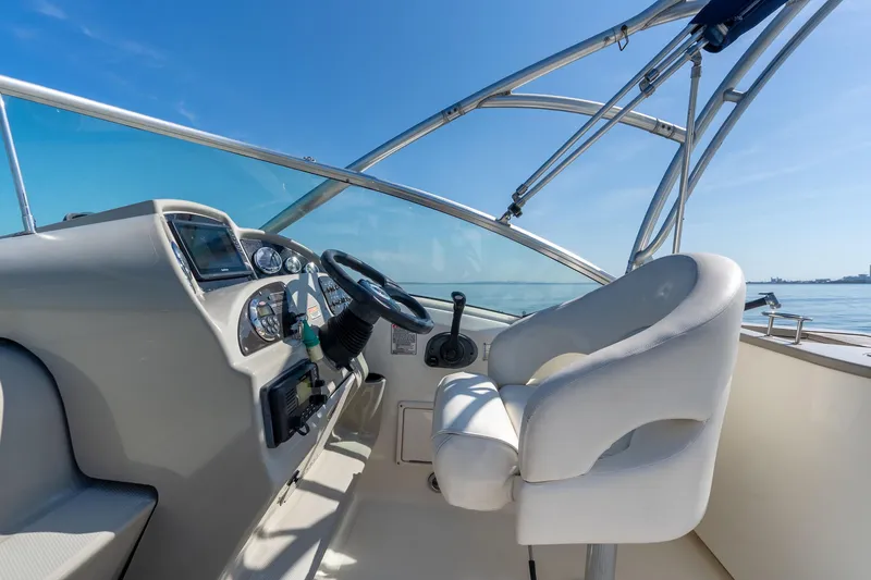 Slide: The Image of Helm of 2005 Sea Ray 270 Amberjack boat with steering wheel and controls. - 18
