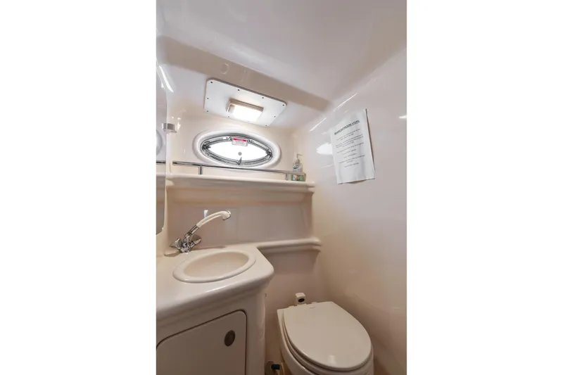Slide: The Image of Interior of 2005 Sea Ray 270 Amberjack boat bathroom with sink and toilet. - 22