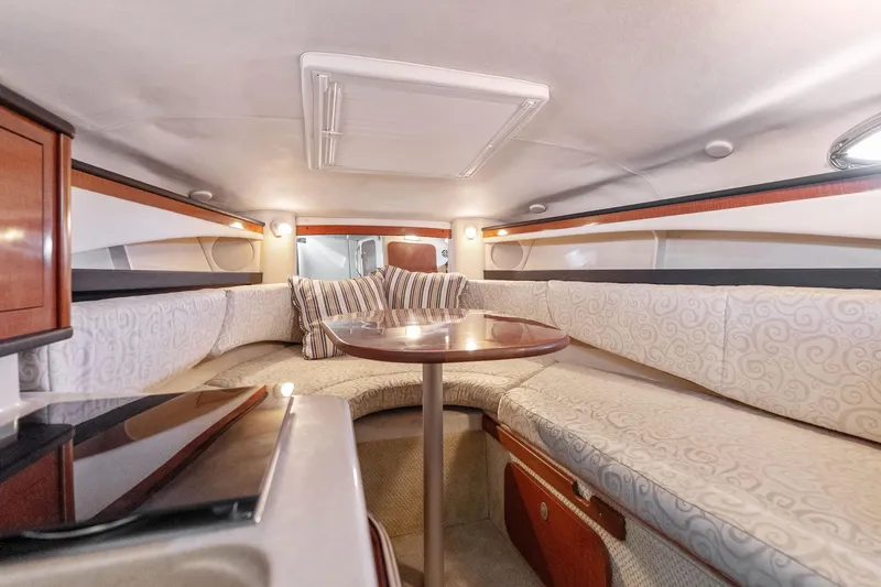 Slide: The Image of Interior of 2005 Sea Ray 270 Amberjack boat with cozy seating and table. - 21