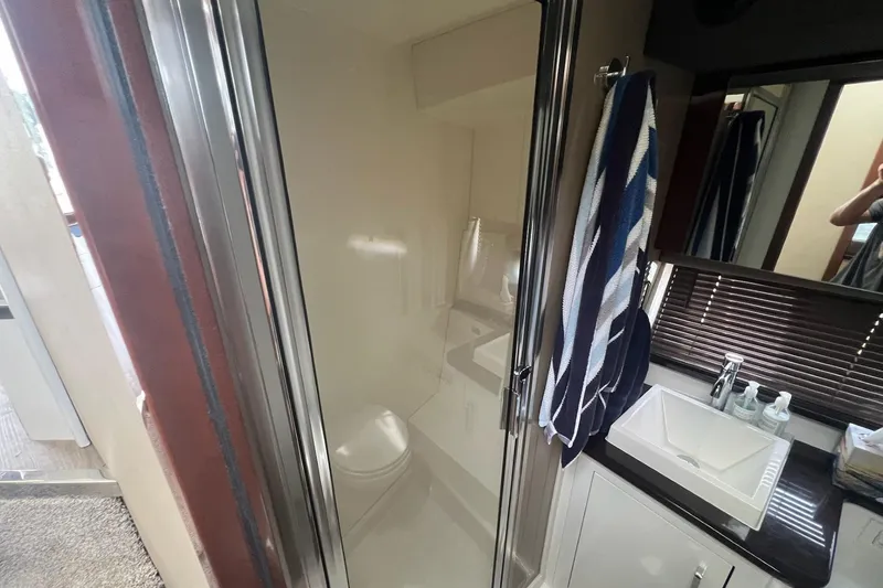 Slide: The Image of Bathroom interior of 2019 Carver C37 yacht with shower, sink, and towel. - 38