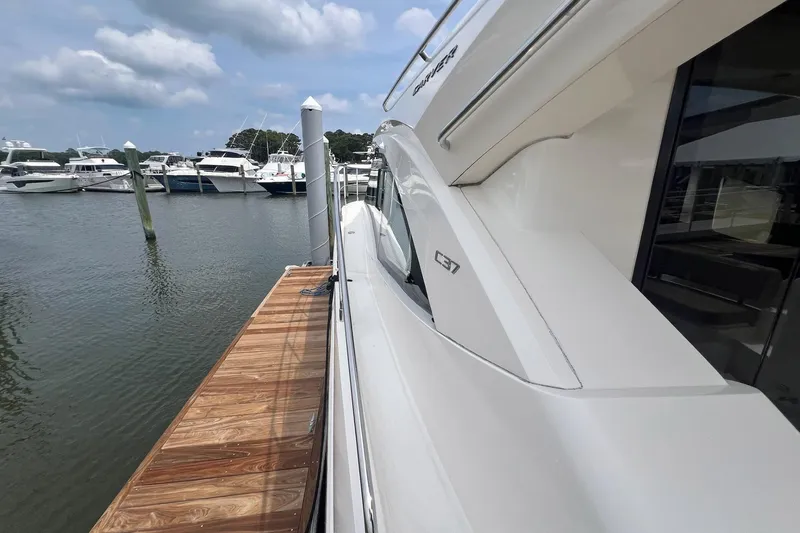 Slide: The Image of 2019 Carver C37 yacht docked at marina, showcasing sleek design and luxury features. - 7