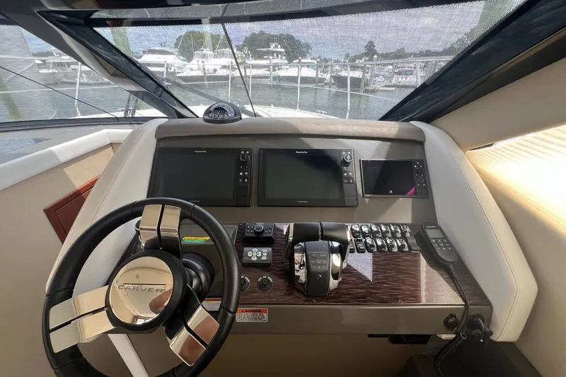 Slide: The Image of Helm of 2019 Carver C37 yacht with steering wheel and navigation controls. - 40