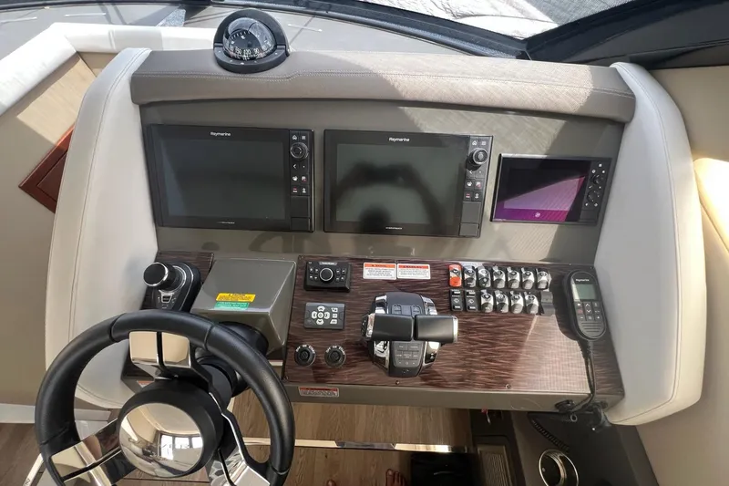 Slide: The Image of Helm of 2019 Carver C37 yacht with navigation screens and controls. - 39