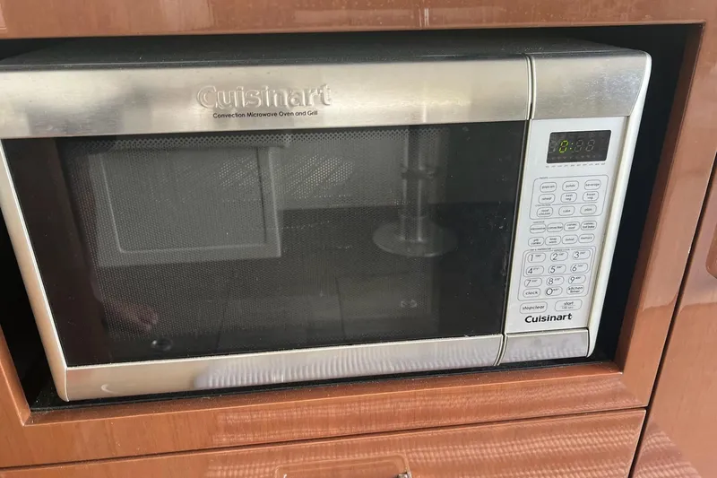Slide: The Image of Cuisinart convection microwave oven with digital controls, set in a wooden cabinet. - 31