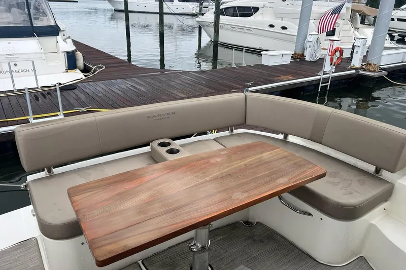 Slide: The Image of Cozy seating area on 2019 Carver C37 yacht at marina dock. - 16