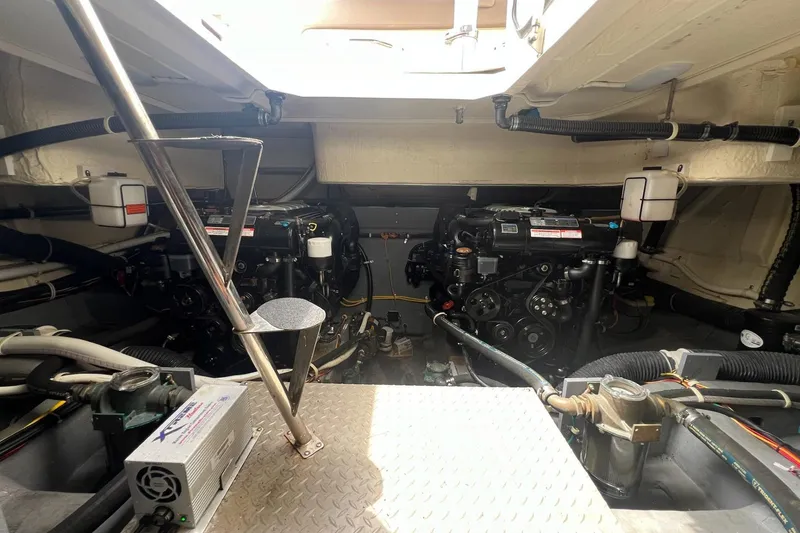 Slide: The Image of Engine room of a 2019 Carver C37 yacht, showcasing dual engines and mechanical components. - 44