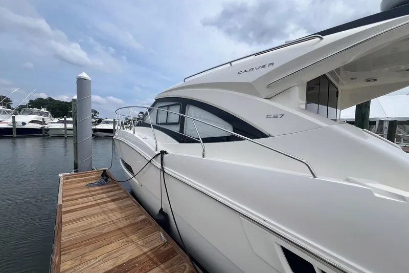 Slide: The Image of 2019 Carver C37 yacht docked at marina, showcasing sleek design and modern features. - 8