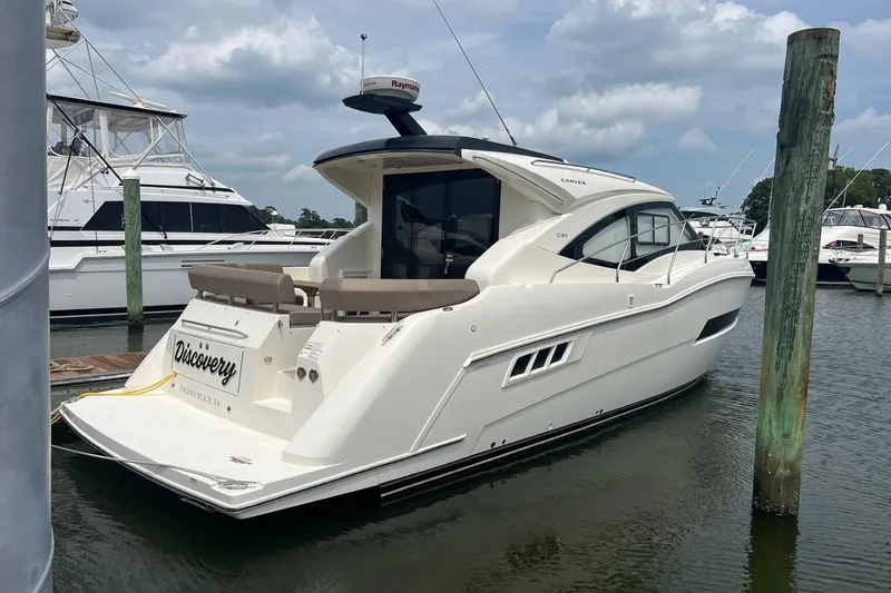 Slide: The Image of 2019 Carver C37 yacht docked at marina under cloudy sky. - 4