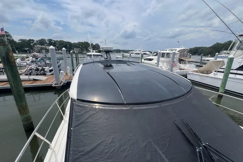 Slide: The Image of 2019 Carver C37 yacht docked at a marina under a cloudy sky. - 20