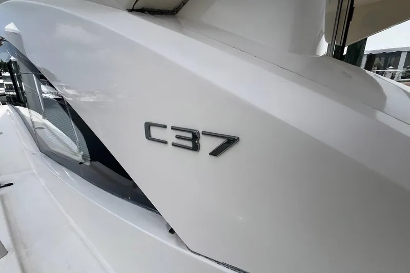 Slide: The Image of 2019 Carver C37 yacht exterior with sleek white design and model emblem. - 10