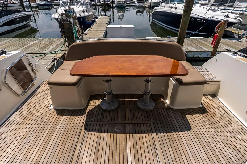 Slide: The Image of Luxury yacht deck with wooden table and seating, Prestige 450S, 2015 model, docked at marina. - 6