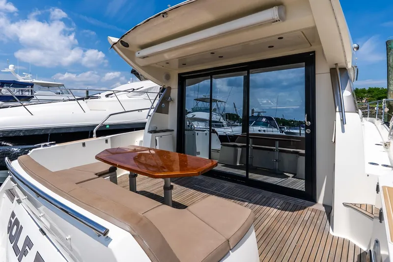 Slide: The Image of Luxury yacht deck of 2015 Prestige 450S with seating and table, docked at marina. - 4